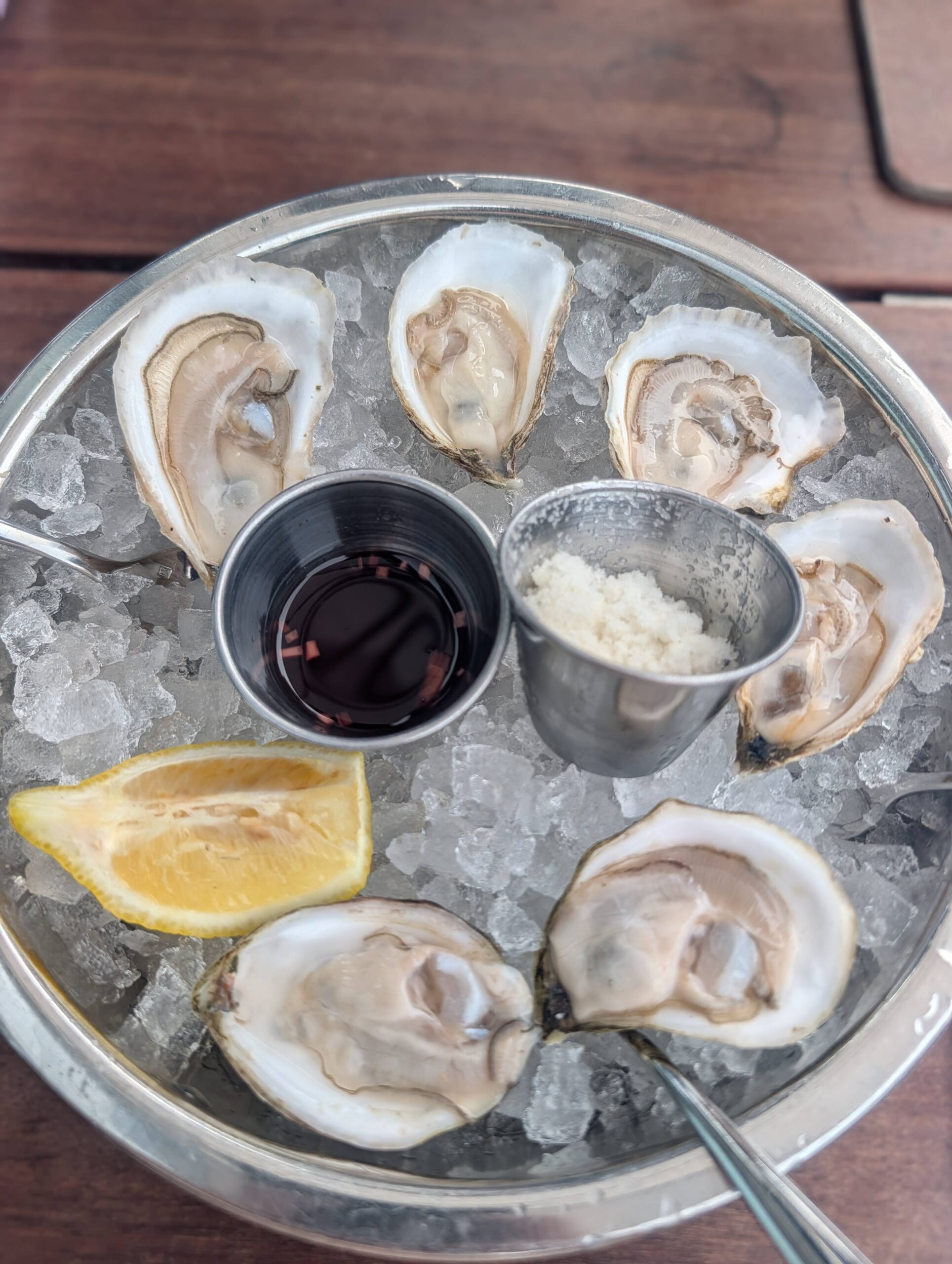A plate of raw Maine oysters on ice with mignonette at Eventide