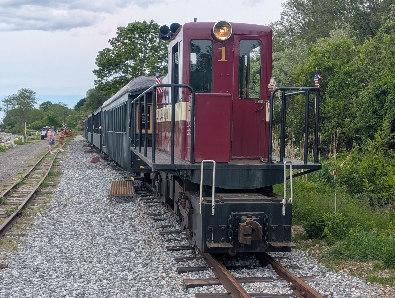 The Maine Narrow Gauge Railroad's maroon locomotive No. 1 coupled to the antique passenger cars