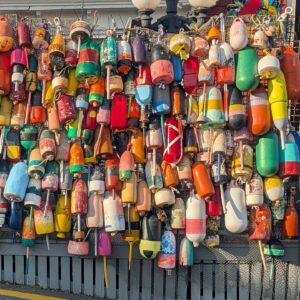 A wall of colorful Maine lobster buoys in Boothbay Harbor