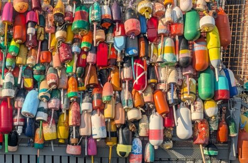 A wall of colorful Maine lobster buoys in Boothbay Harbor